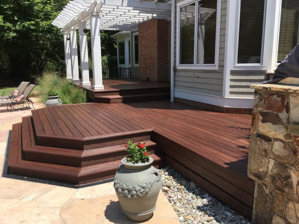 Elegant wooden deck with built-in seating and decorative planter.