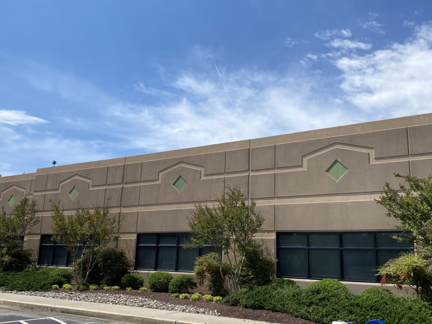 Exterior view of a modern commercial building under a clear blue sky.